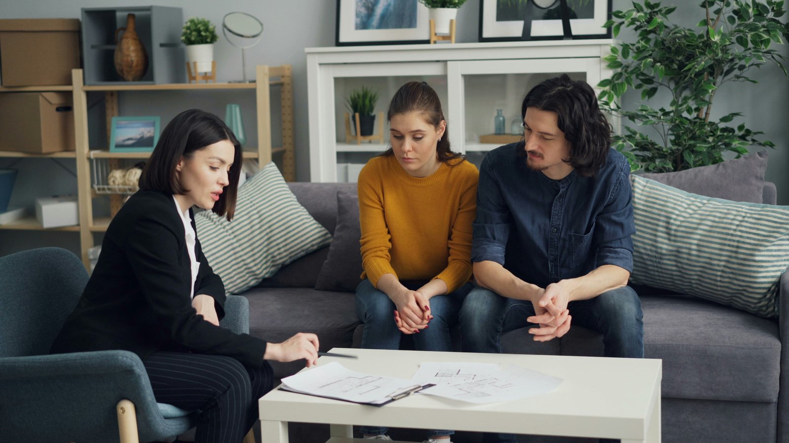 A solicitor discussing estate planning documents with a client couple